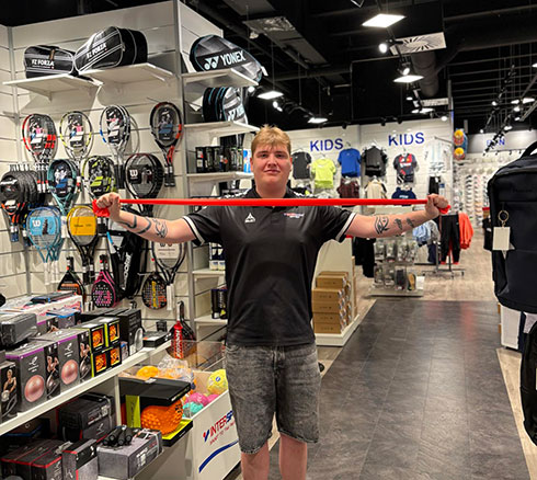 medarbejder fremviser træningselastik i butik